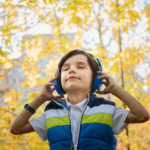 Junge hört mit Kinderkopfhörern Musik