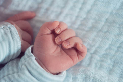 Newborn baby hands close up with selective focus