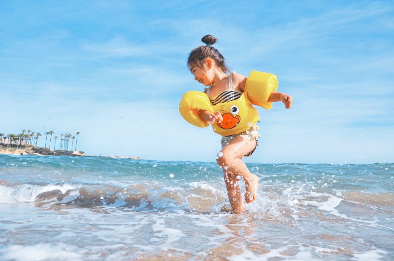 Kind in Schwimmflügeln mit Brustgurt
